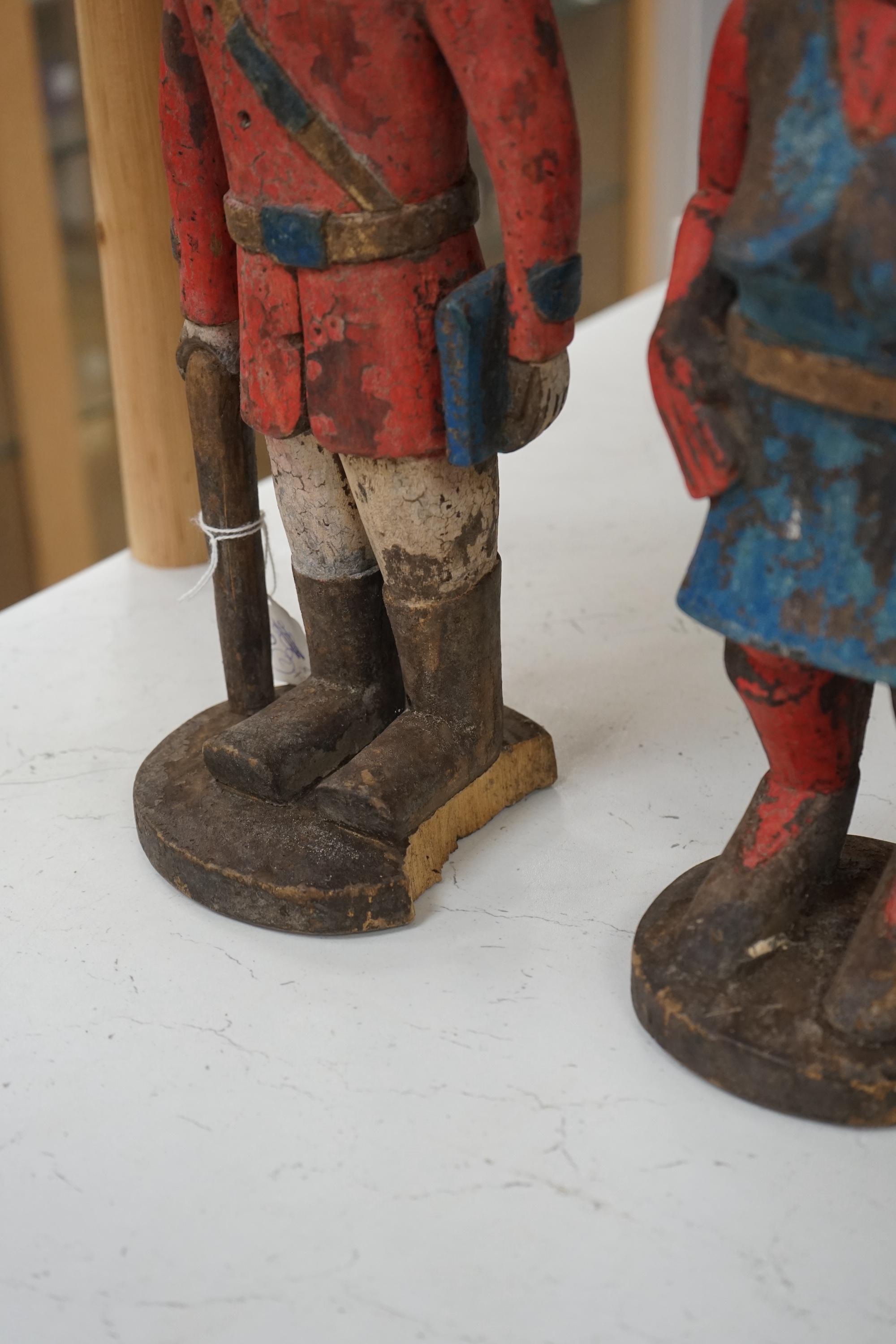 A 20th century West African carving of a colonial military figure and another similar, largest 48cm high. Condition - largest figure chipped